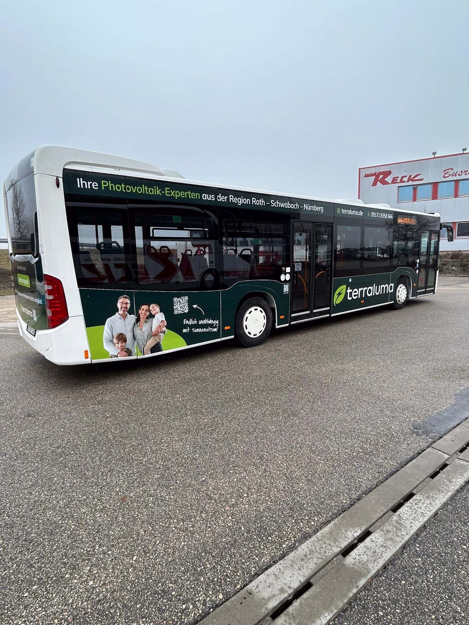 Einstiegsseite eines dunklen Busses mit Werbung der terraluma GmbH