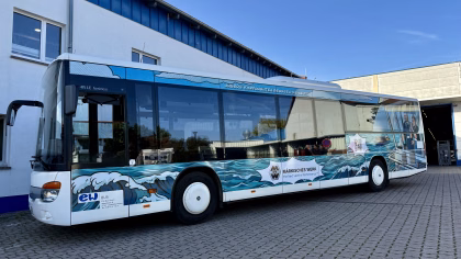 Außenseite eines blauen Stadtbusses mit Werbung des Märkischen Werks